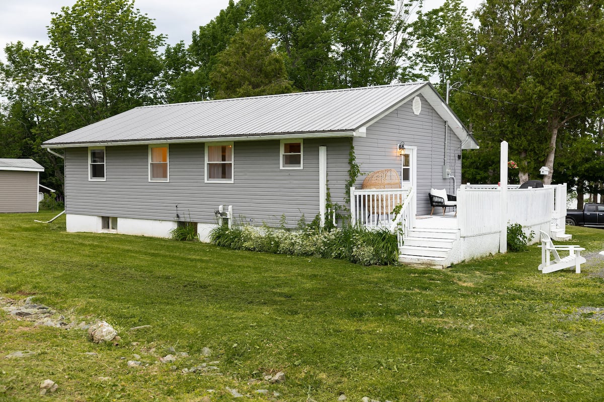 The side of the house, with the white deck and steps